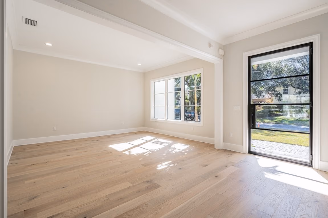 Bright room with oak floors and a large black-framed glass door