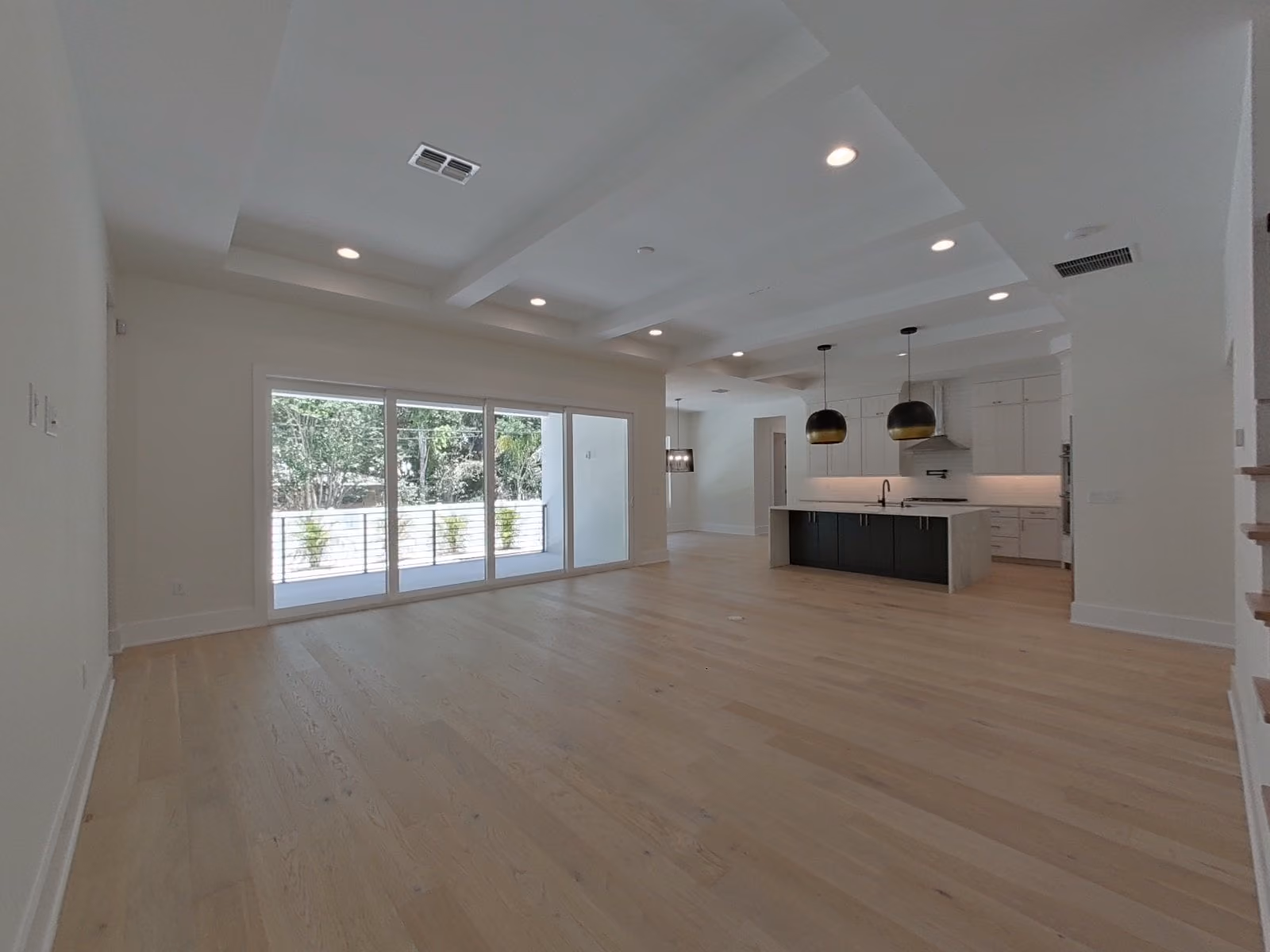 Great room looking toward the kitchen past sliding glass doors