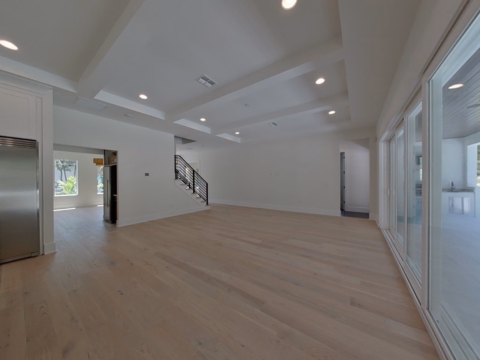 Open living area with sliding glass doors and a stair
